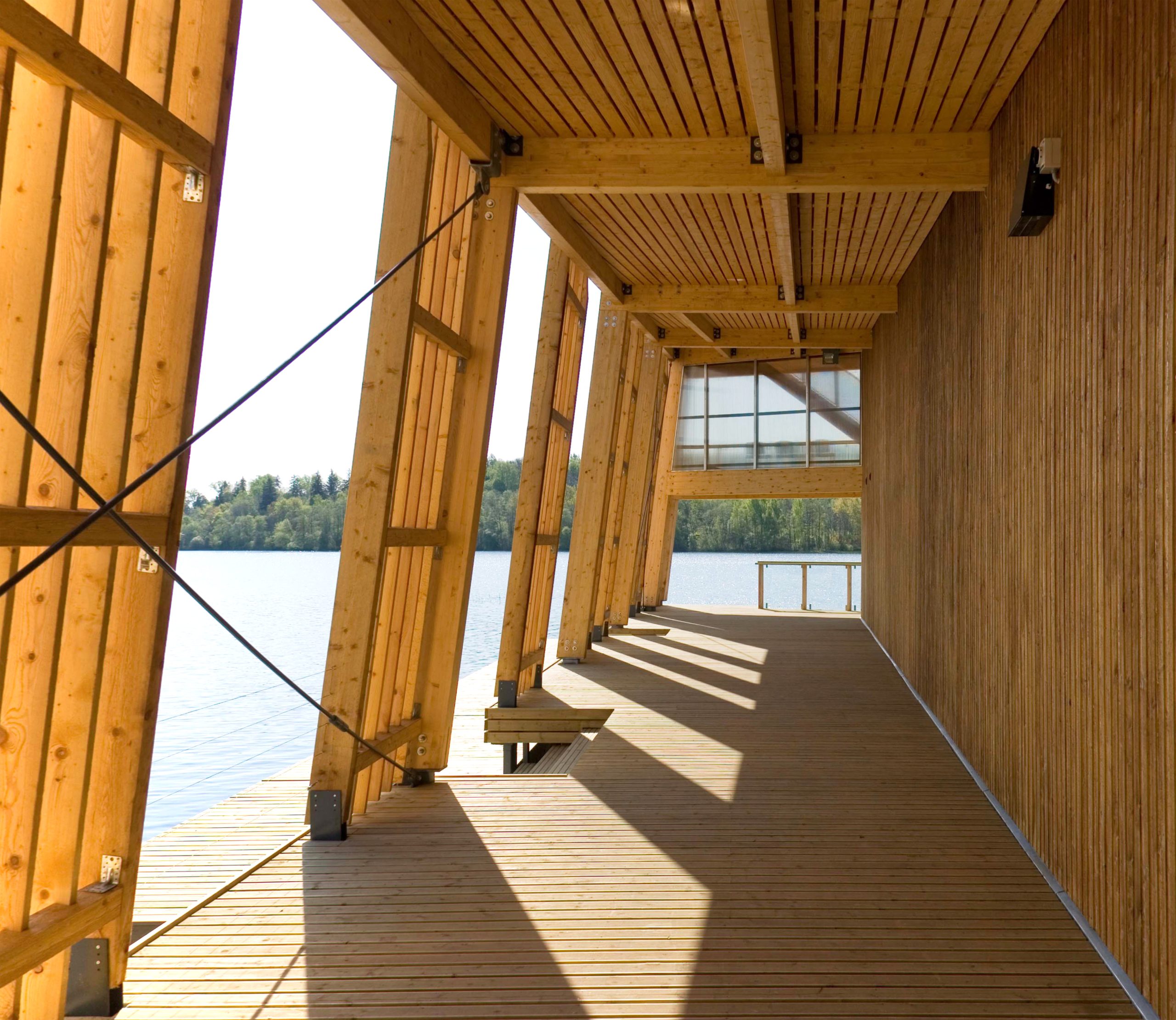 Exterior porch of wooden boathouse on river or waterfront.